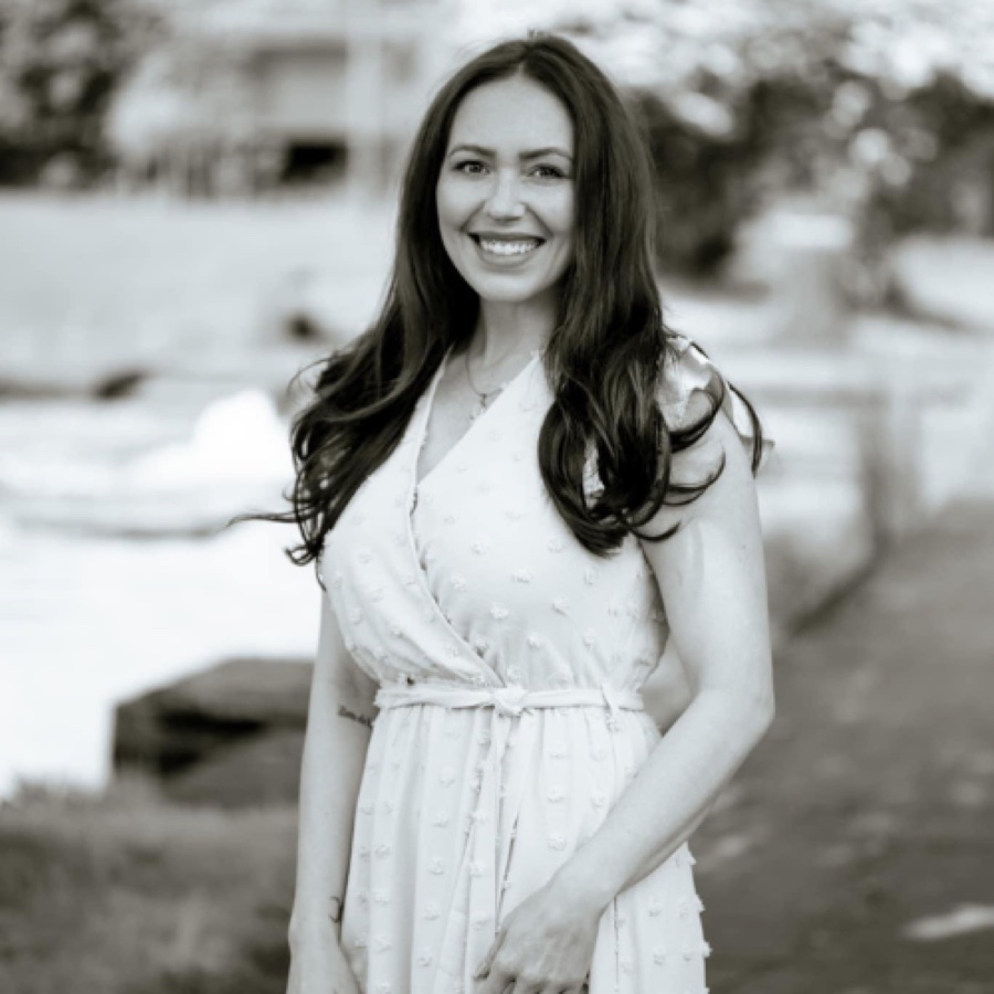 Black-and-white portrait of Samantha in a polka-dot dress by the waterfront